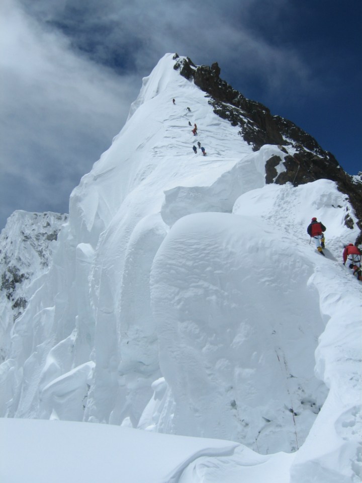 A small rock step bars the way to the false summit slopes
